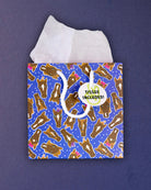 Hairy Styles small gift bag front-on, Tissue Included tag resting on the square blue pony panel.