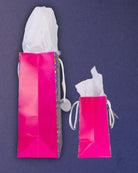 Hairy Styles gift bags in medium and small side by side, both hot pink gussets facing the camera.