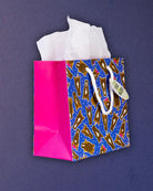 Hairy Styles small gift bag angled left, hot pink gusset beside the square blue printed panel.