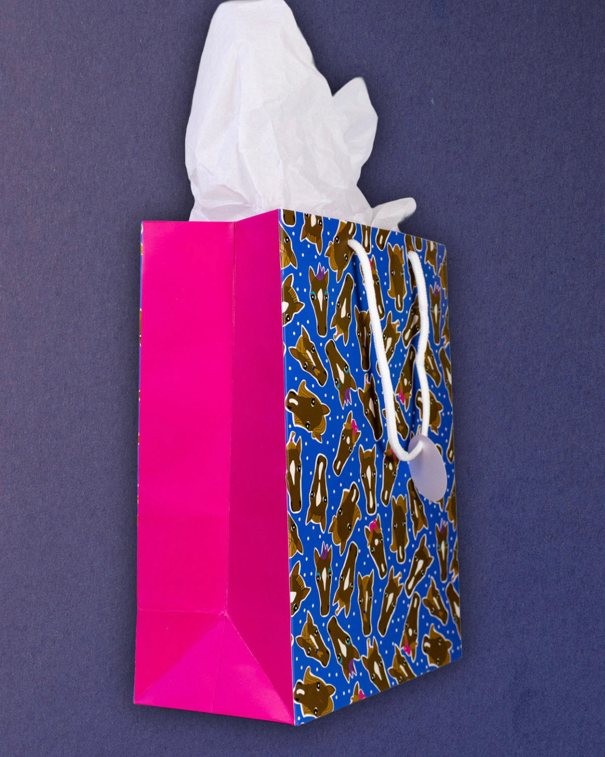 Hairy Styles medium gift bag turned steeply, the hot pink gusset taking up half of the frame.