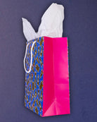 Hairy Styles medium gift bag tipped to the right, pink gusset and the triangular base fold in view.