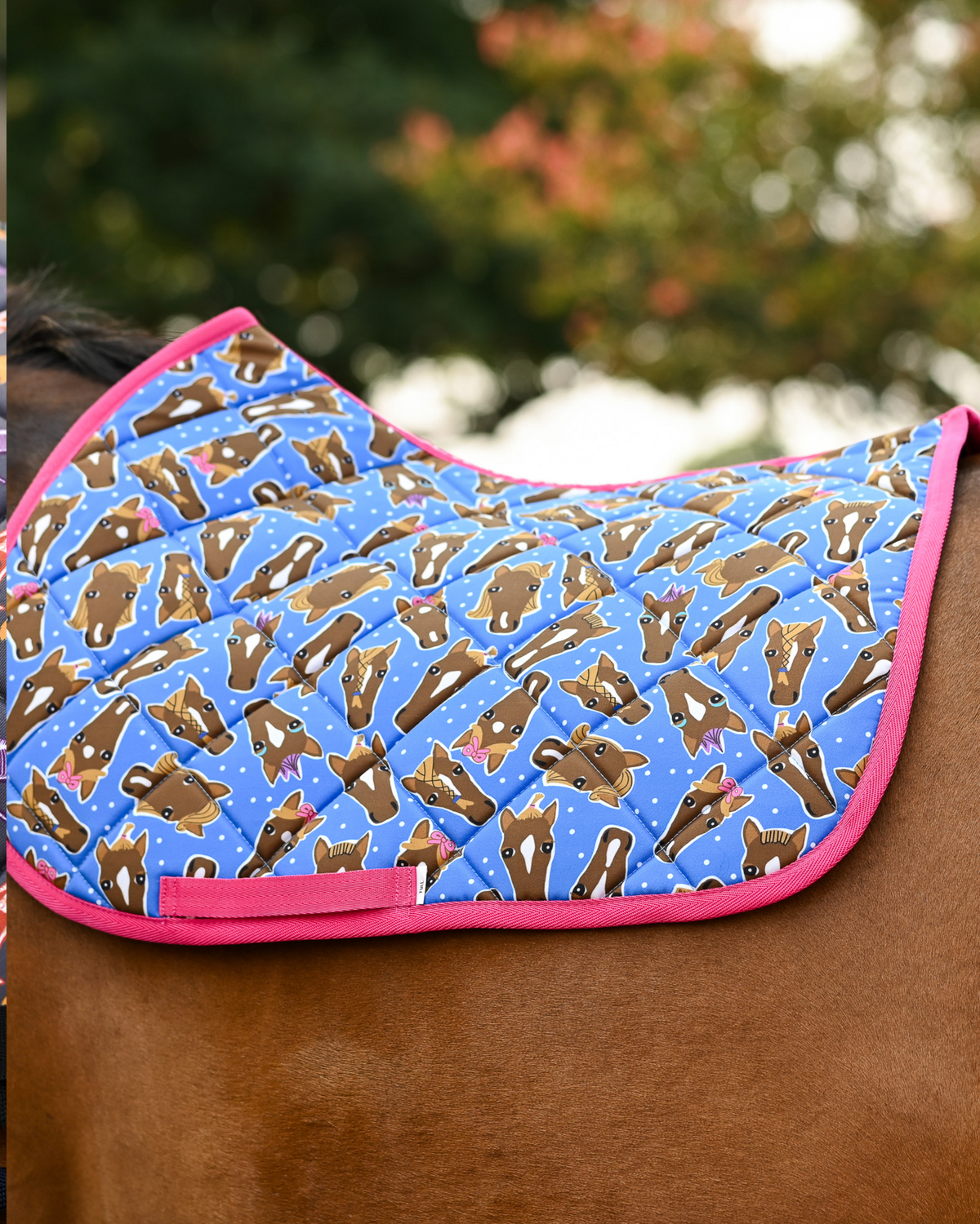Bright blue Hairy Styles pad printed with brown horse heads in bows and braids, hot pink binding, no saddle