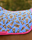 Close view of the Hairy Styles print — braided horse heads and white dots on blue, edged in hot pink