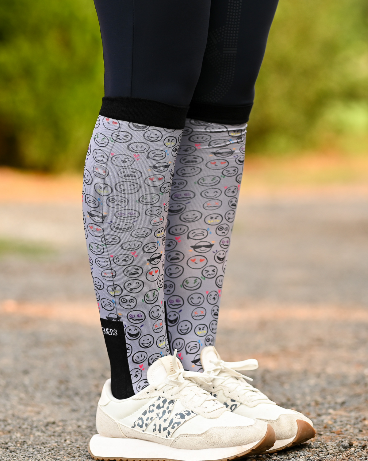 Horse Ownership riding boot socks styled over breeches, soft grey with the emoji faces of horse ownership