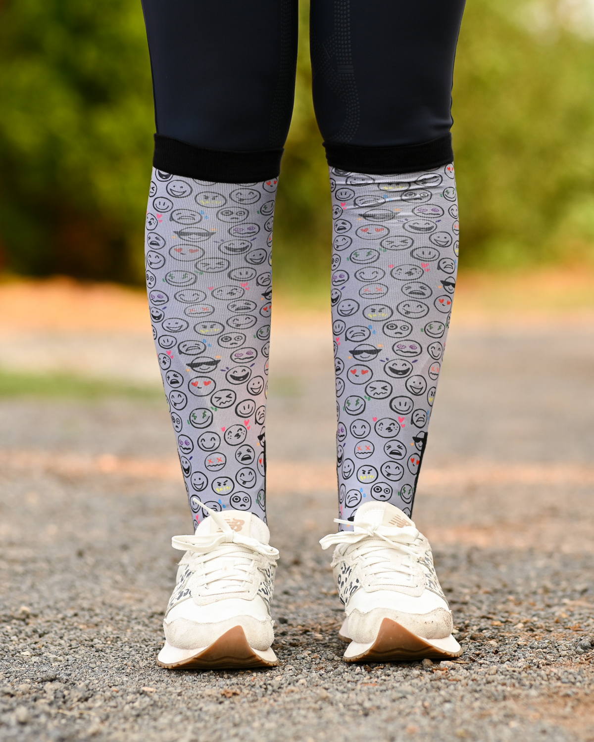 Horse Ownership equestrian boot socks worn at the barn, soft grey with the emoji faces of horse ownership