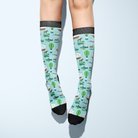 Limited Edition Pony Island Pony Transport Socks with cheerful ponies and adventure-themed design on light blue background