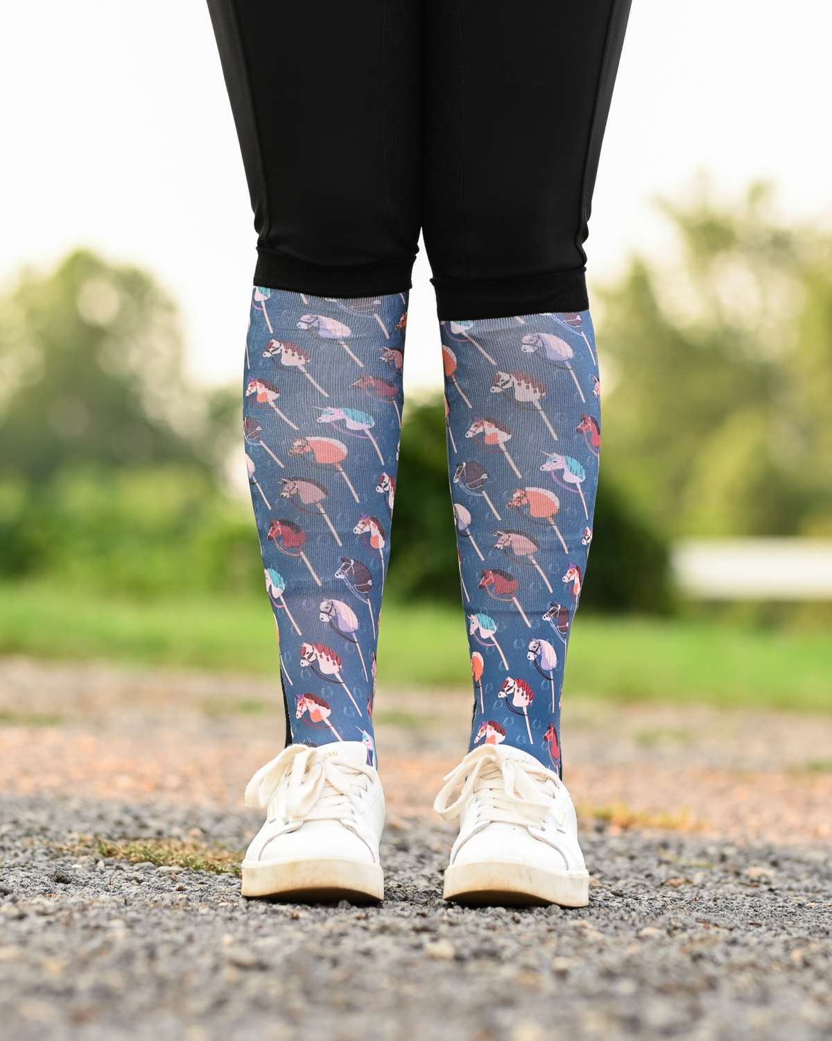 It's Not a Hobby equestrian boot socks worn at the barn, slate blue with hobby horses on wooden sticks