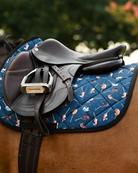 Teal It's Not a Hobby pad under a brown close-contact saddle, girth and stirrup, on a bay horse