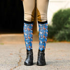 Colorful horse pattern boot socks with black stretchy top, flat seam toe, and terry foot bottom for riding boots