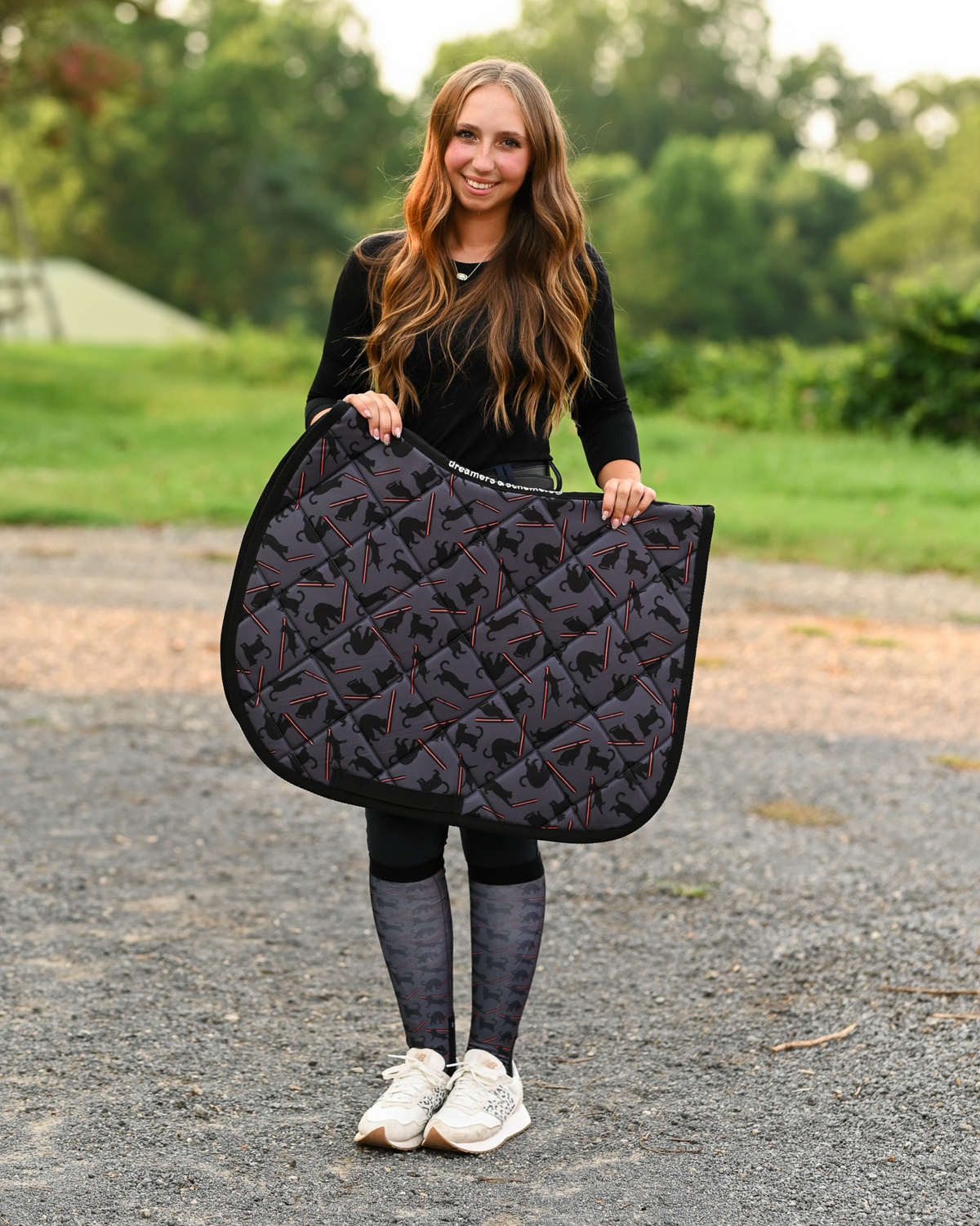 Laser Cats saddle pad carried at the barn, charcoal quilting printed with black cats firing red laser beams