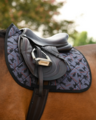 Laser Cats pad in grey with black binding, tacked up under a brown jump saddle on a bay horse