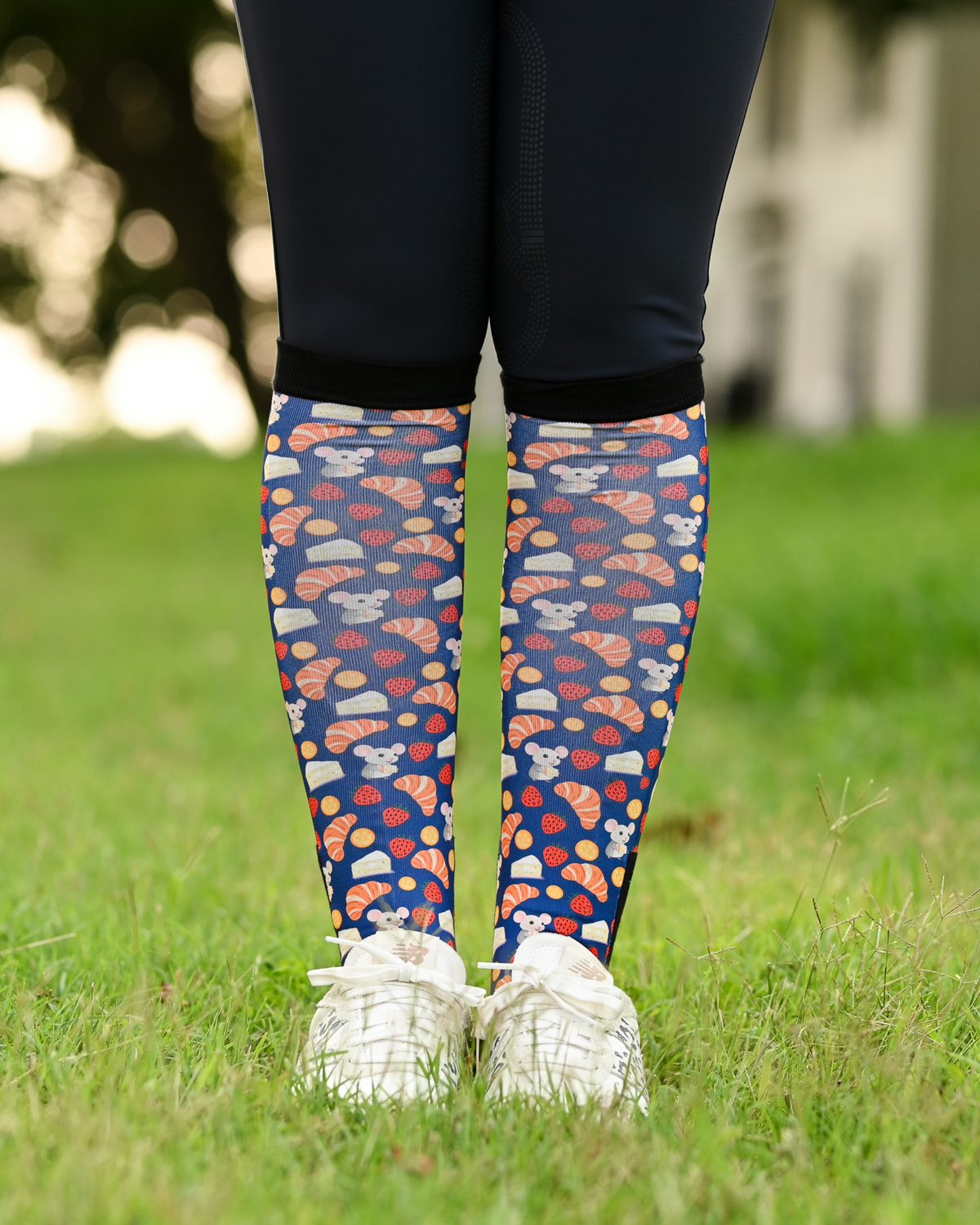 Merci riding boot socks styled over breeches, navy with croissants, macarons and strawberries