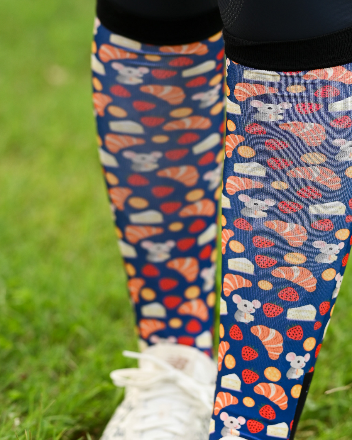 Close crop of the Merci boot sock print, croissants, macarons and strawberries on navy