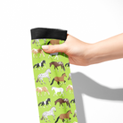 Limited Edition Pony Island Neon Ponies Socks with colorful horse pattern on green background, held in hand