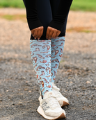 Otter-ly Adorable Pair & a Spare boot socks worn on the calf, pale blue with otters floating and holding hands