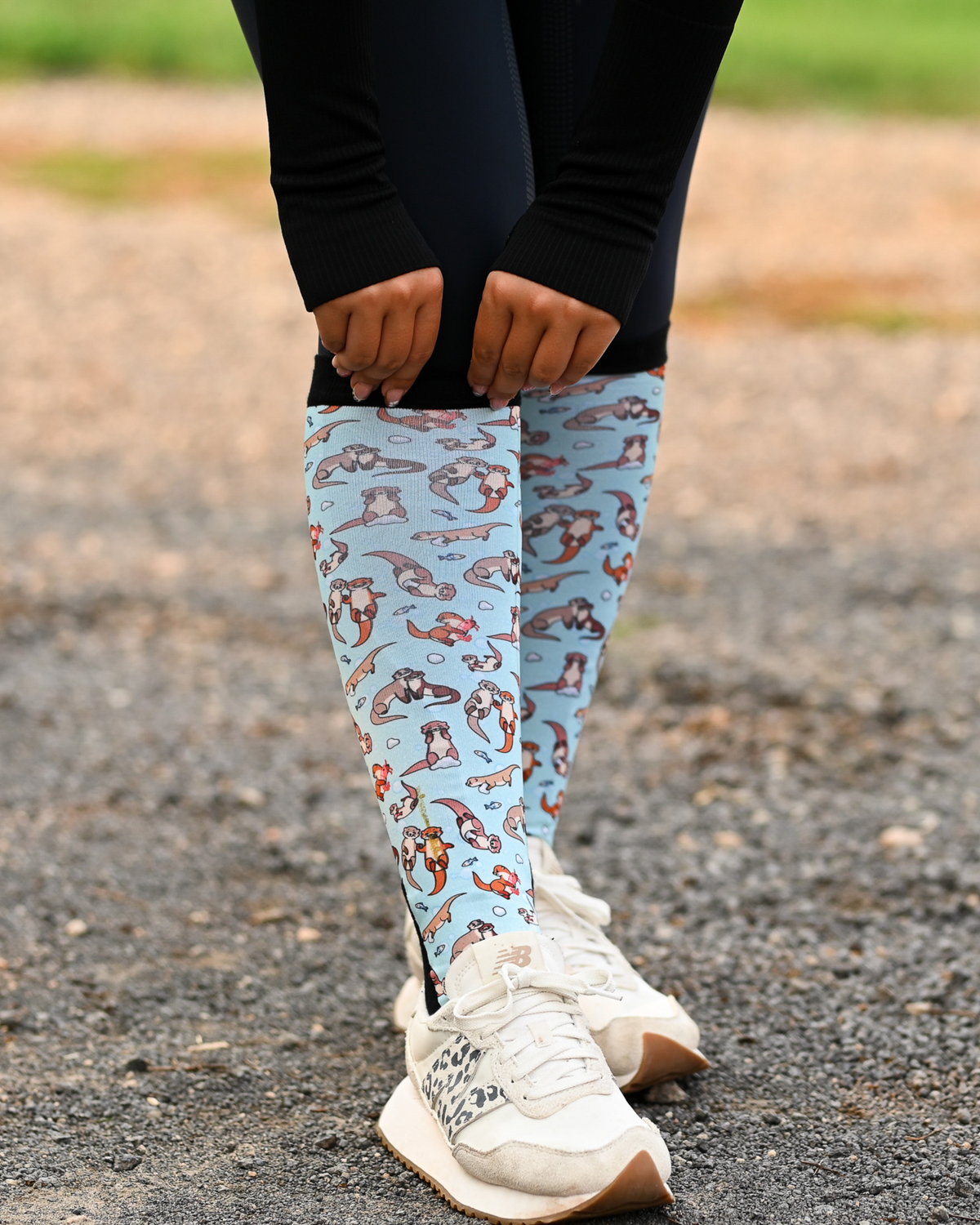 Otter-ly Adorable Pair & a Spare boot socks worn on the calf, pale blue with otters floating and holding hands