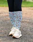 Otter-ly Adorable equestrian boot socks worn at the barn, pale blue with otters floating and holding hands