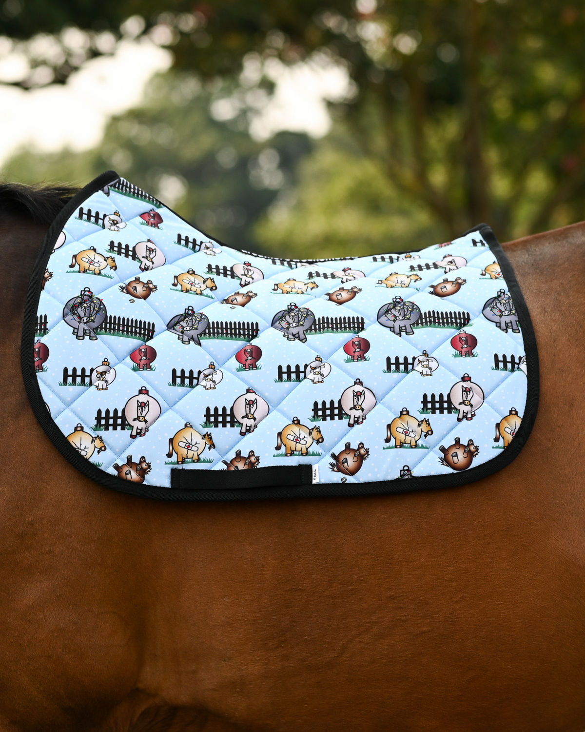 Pasture Ornaments saddle pad in light blue, horses drawn as Christmas baubles, shown with no saddle