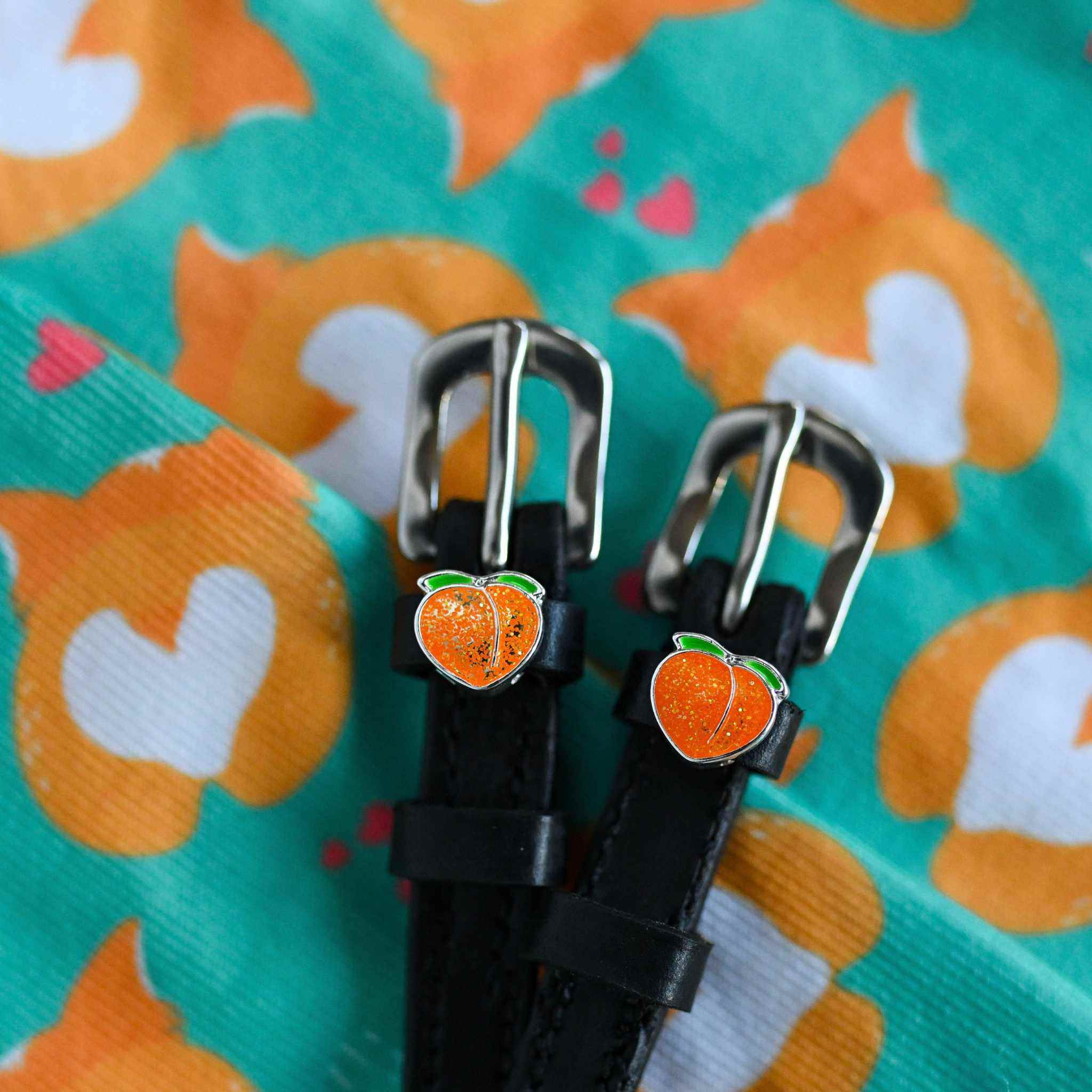 Peach Spur Straps ManeJane black leather spur straps with non-stretch interior and stainless steel buckle for English ridin.