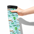 Hand holding Limited Edition Pony Island Pony Transport Socks with pony and transport vehicle design on light blue background