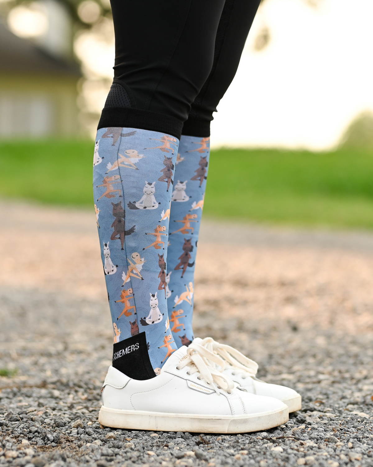 Pony Pilates equestrian boot socks worn at the barn, soft blue with horses stretching through yoga poses