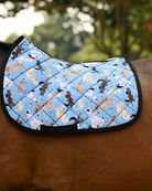 Pony Pilates saddle pad in denim blue, horses stretching in yoga poses, worn bare on a bay horse