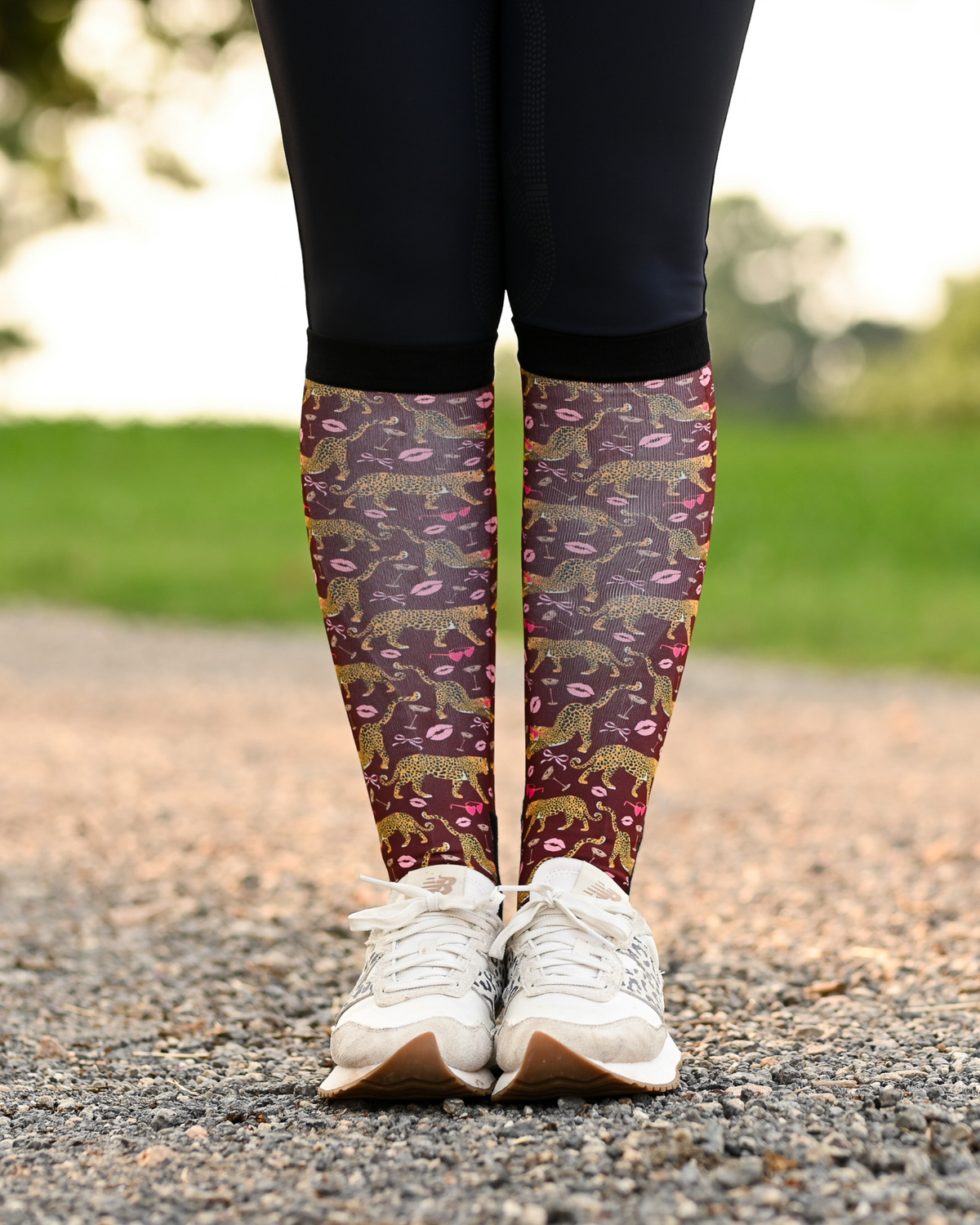 Ready to Play equestrian boot socks worn at the barn, burgundy with gold leopards, pink lips and bows