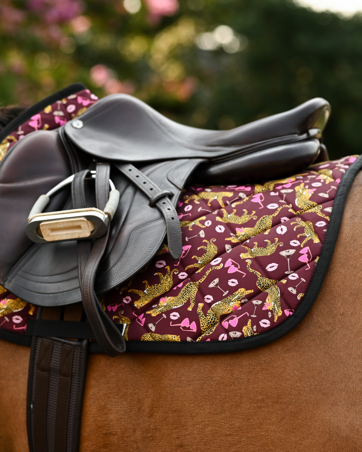 Ready to Play saddle pad in burgundy, tacked up on a chestnut horse with a brown jumping saddle