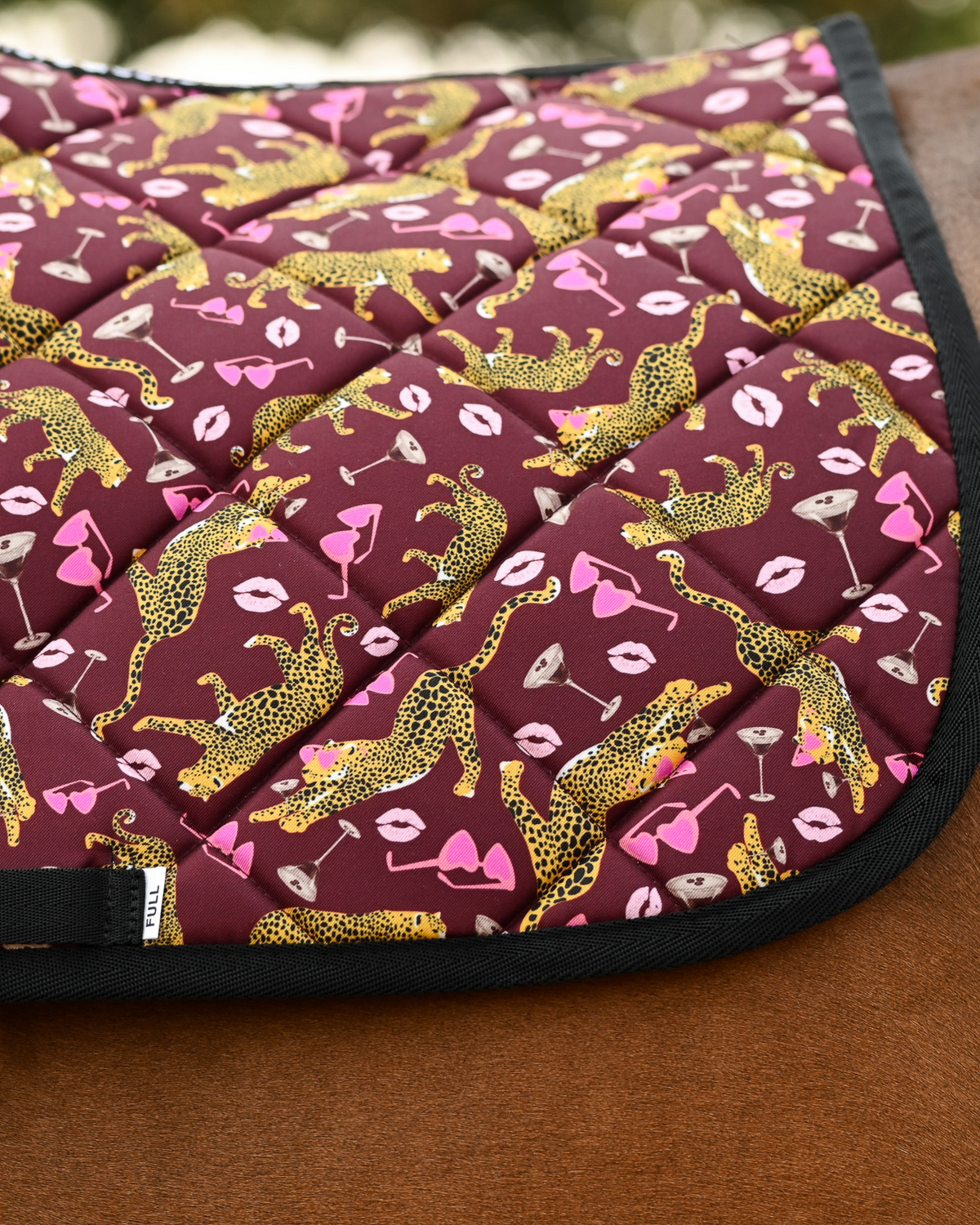 Close view of the Ready to Play print — gold leopards, heart sunglasses and martinis on burgundy