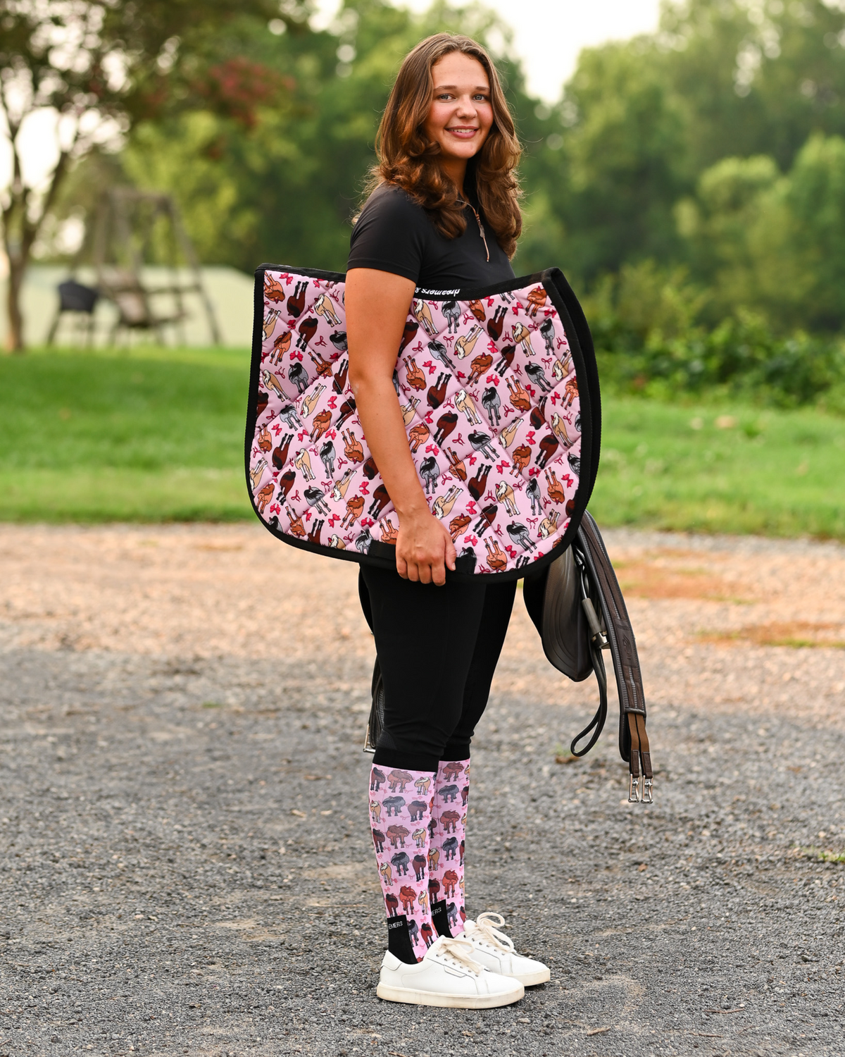 Red Ribbon Girlies all-purpose saddle pad in pink, printed with horse hindquarters tied with red bows