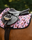 Light pink Red Ribbon Girlies pad under a brown close-contact saddle and stirrup, black binding