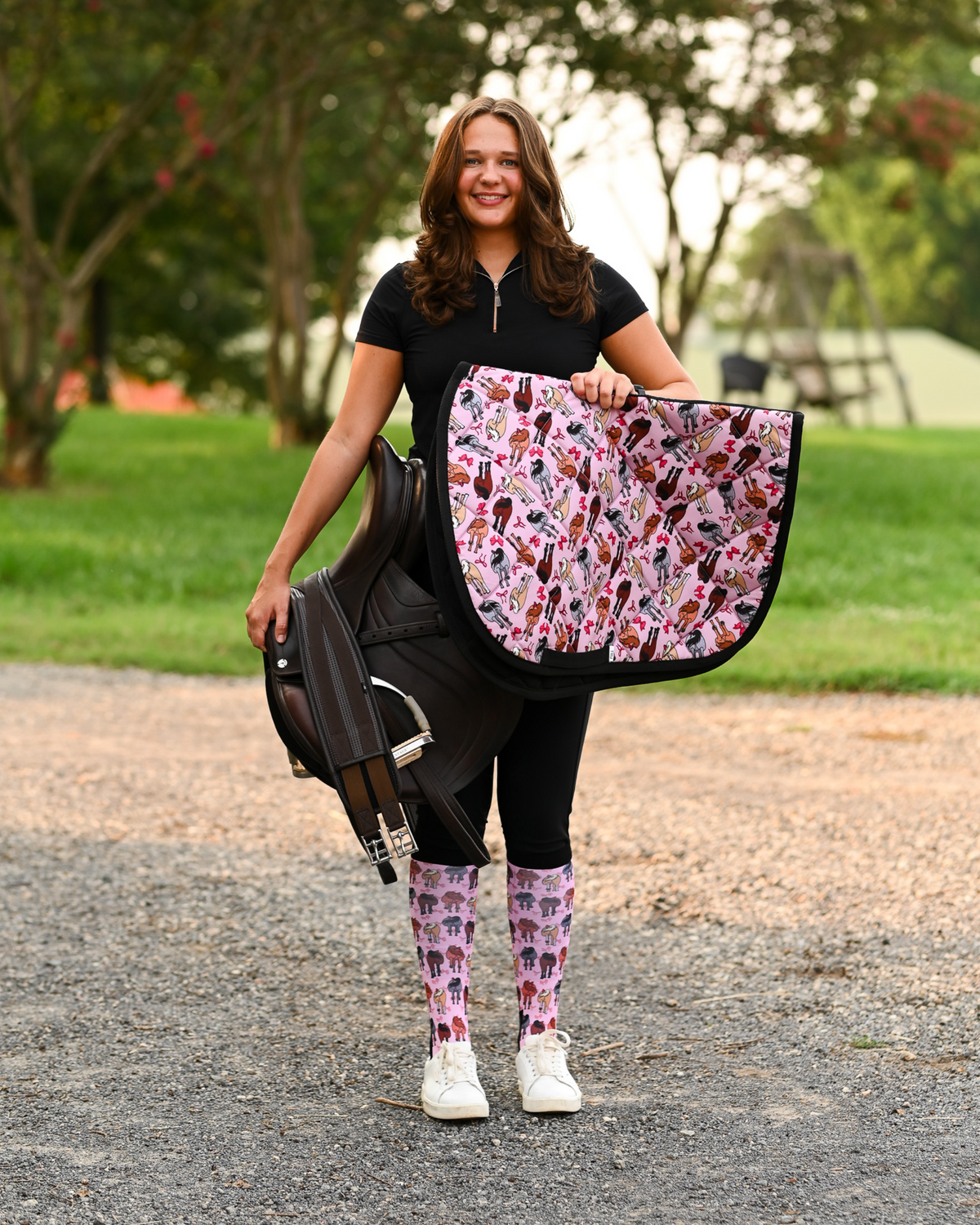 Red Ribbon Girlies all-purpose saddle pad in pink, printed with horse hindquarters tied with red bows