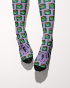 Dumpster Fire socks viewed from the toes, with black toe caps and the Ride for Rayas horse logo on the foot