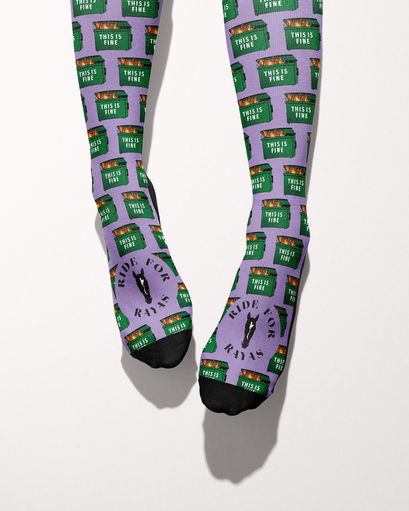 Dumpster Fire socks viewed from the toes, with black toe caps and the Ride for Rayas horse logo on the foot