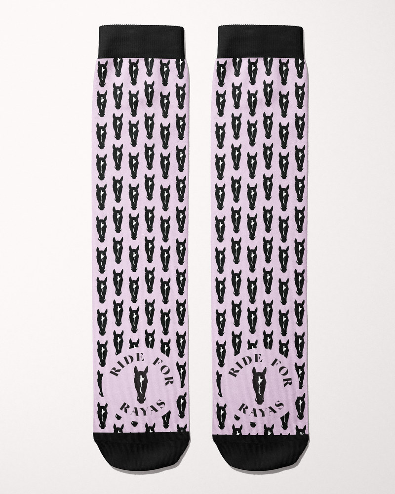 Ride for Rayas Nikko equestrian boot socks in pale pink with black horse heads, flat lay of the pair, by Dreamers & Schemers