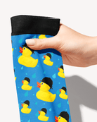 Close-up of the Rubber Ducky boot sock held by its black cuff, yellow rubber ducks in riding helmets on blue