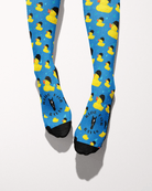 Rubber Ducky socks viewed from the toes, black toe caps and the Ride for Rayas horse logo on the blue duck print