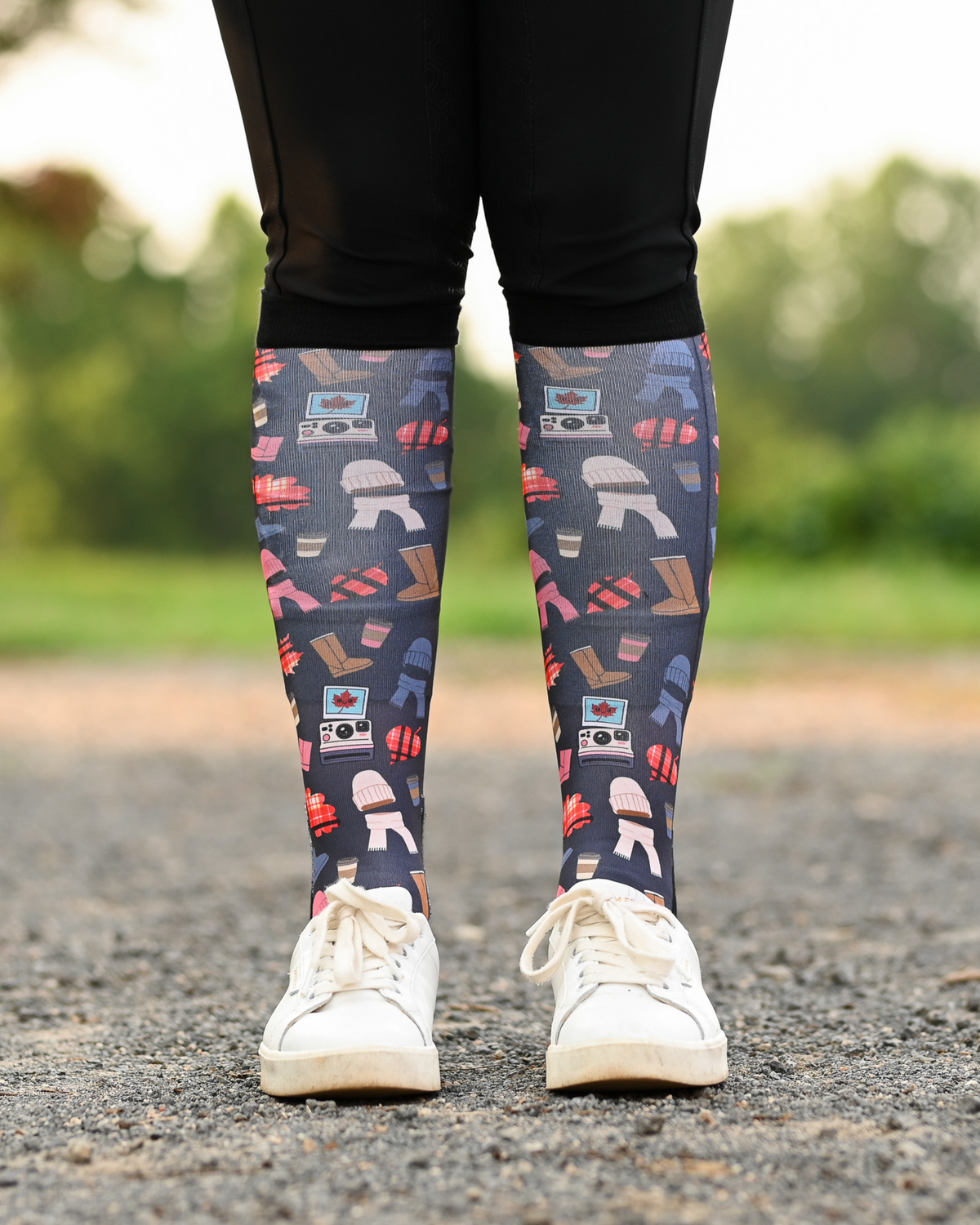 Sept Starter Pack boot socks seen from the front, charcoal ground scattered with autumn boots, plaid, beanies and lattes