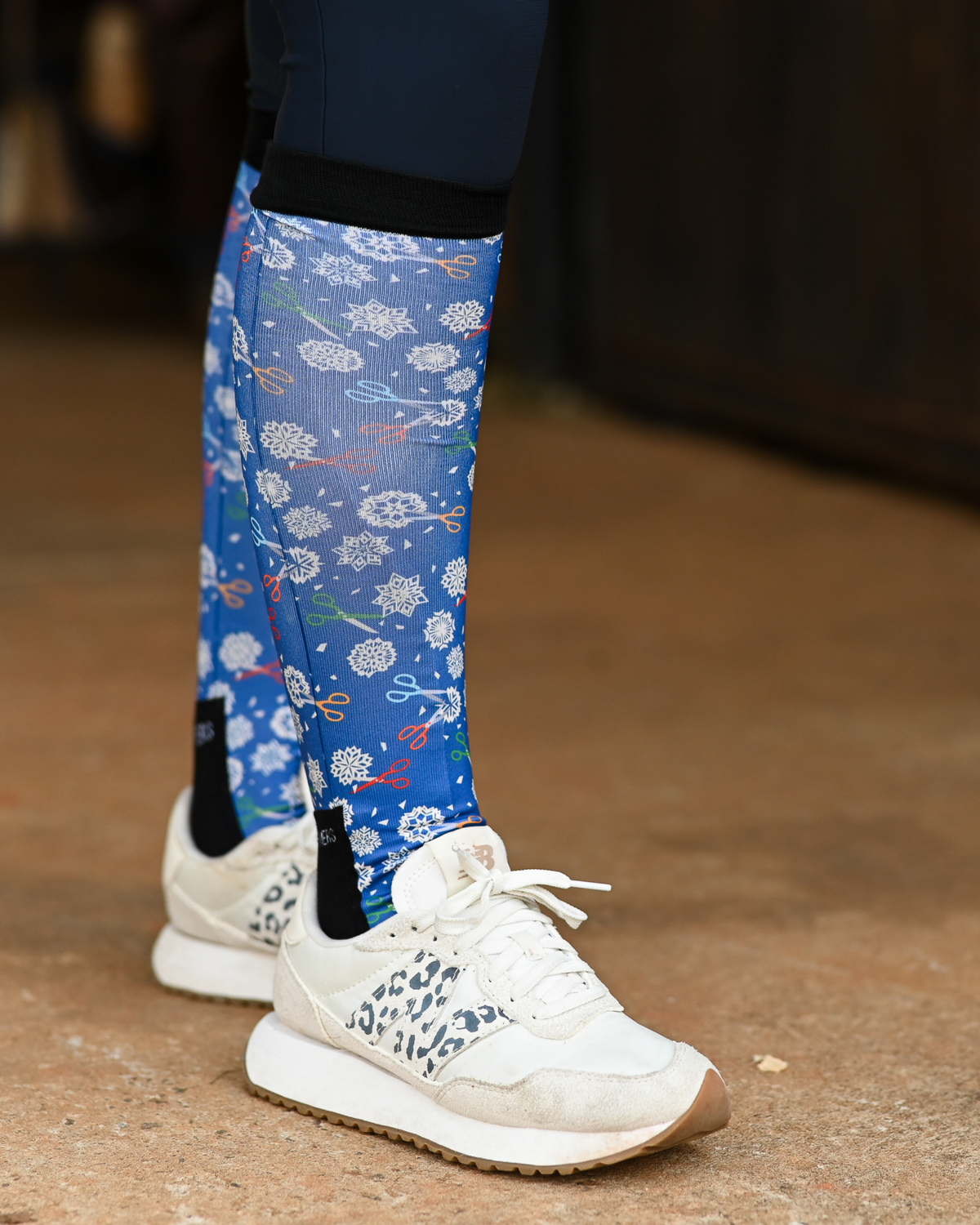 Shear Magic riding boot socks styled over breeches, cobalt blue with white clip rosettes and coloured scissors