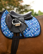Royal blue Shear Magic pad under a brown close-contact saddle, snowflakes and craft scissors on show
