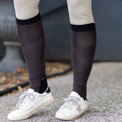 close-up of brown equestrian boot socks worn with white sneakers and beige riding pants