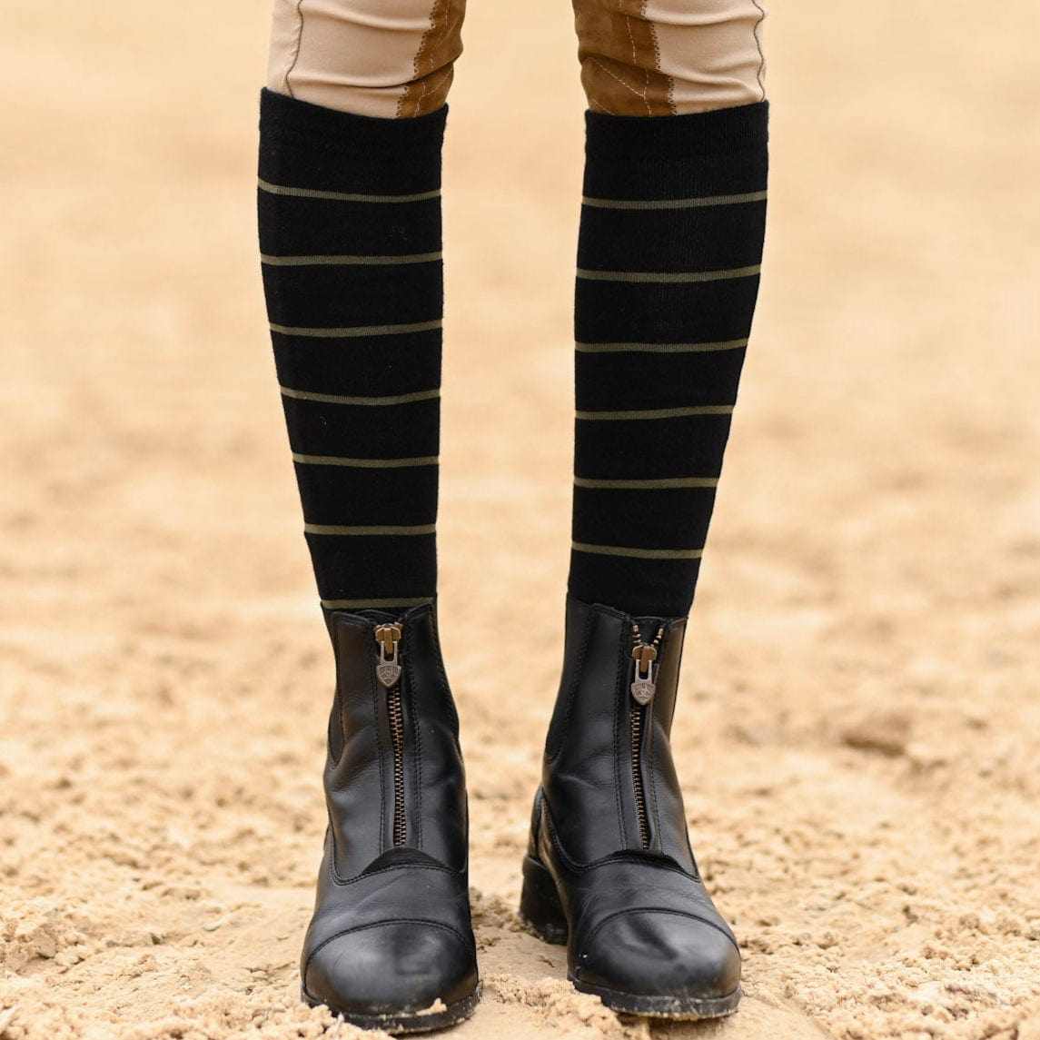 black striped knit boot socks with structured heel and toe worn with equestrian boots