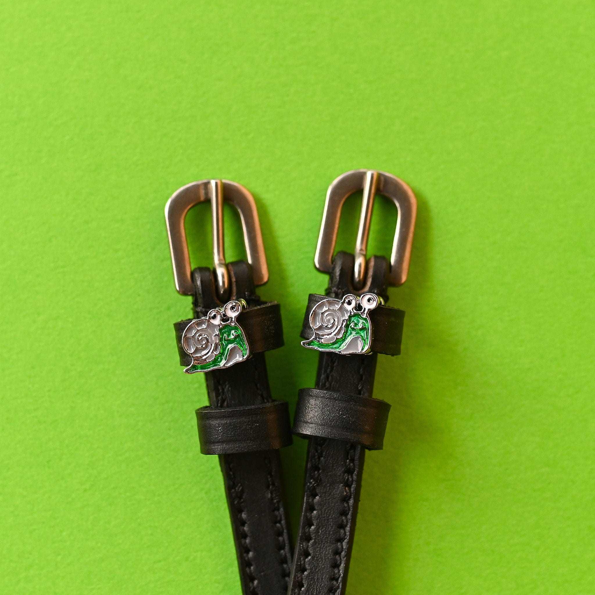 Snail Spur Straps ManeJane black leather spur straps with non-stretch interior and stainless steel buckle for English ridin.