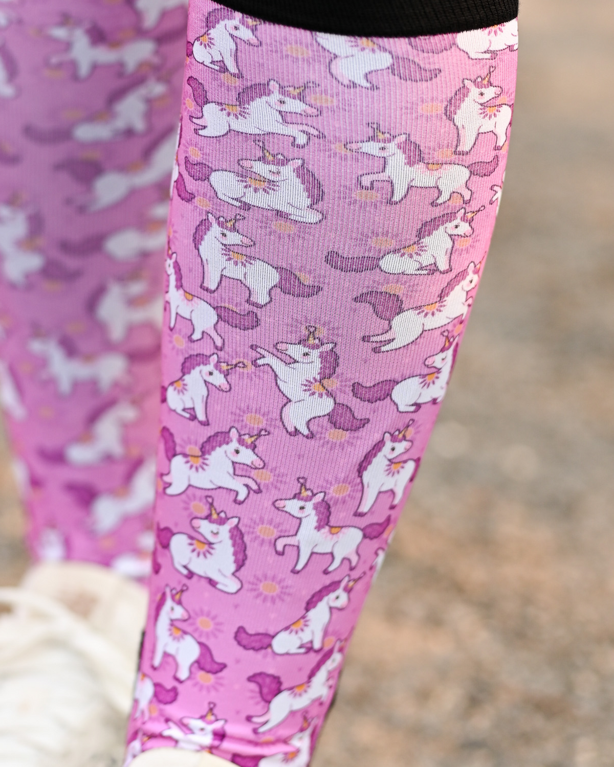 Close crop of the Sunshine and Unicorns boot sock print, white unicorns and yellow suns on bright pink