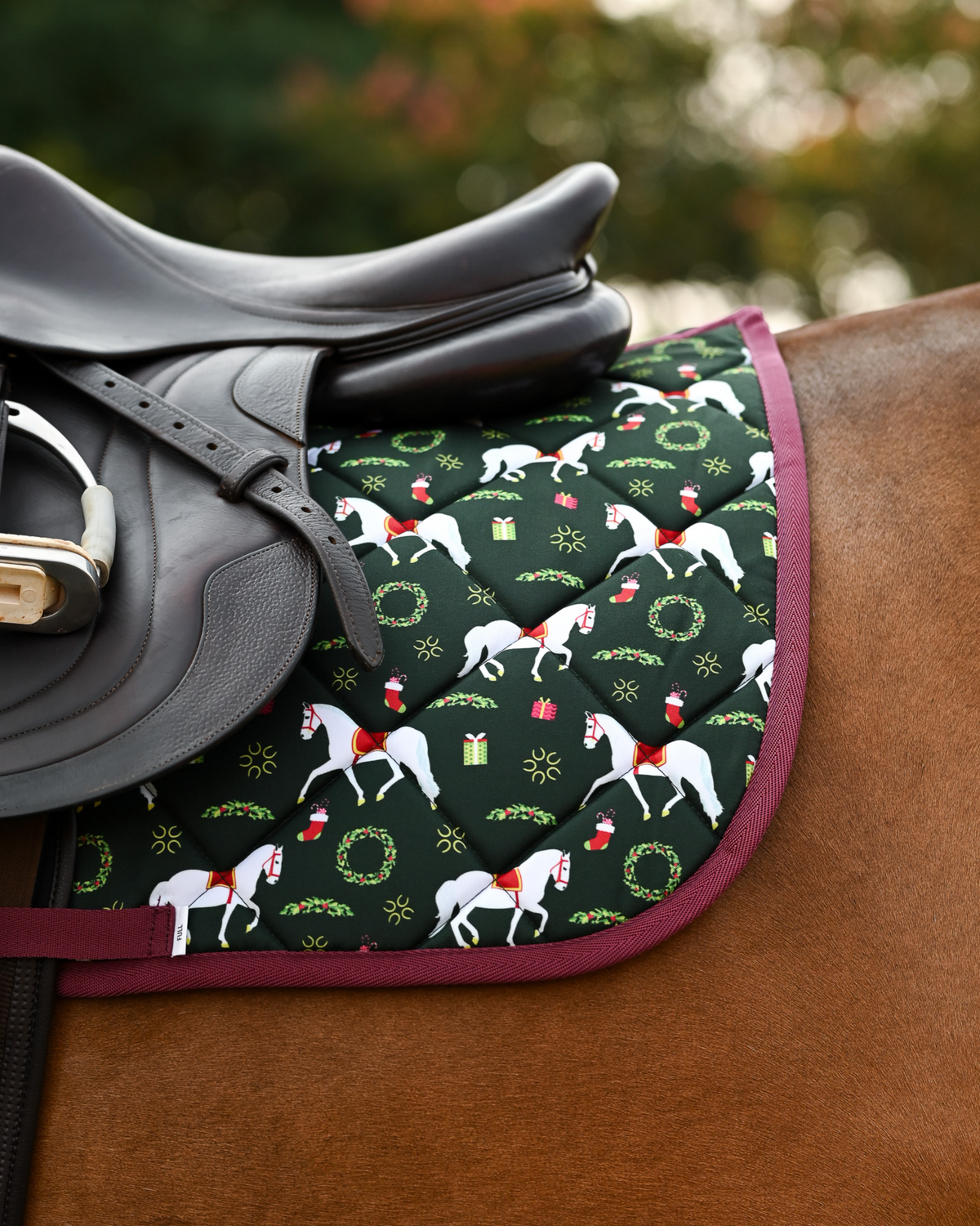 Lippizan Horses holiday pad tacked up on a chestnut horse, white horses and gifts on dark green