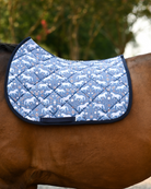 Peppermint Ponies saddle pad in slate blue with white ponies and candy canes, worn with no saddle