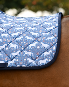 Close view of the Peppermint Ponies print: white ponies, candy canes and peppermint swirls on slate blue