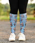 Treat Tax riding boot socks styled over breeches, bright blue with horses in business suits paying the treat tax