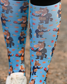 Close crop of the Treat Tax boot sock print, horses in business suits paying the treat tax on bright blue