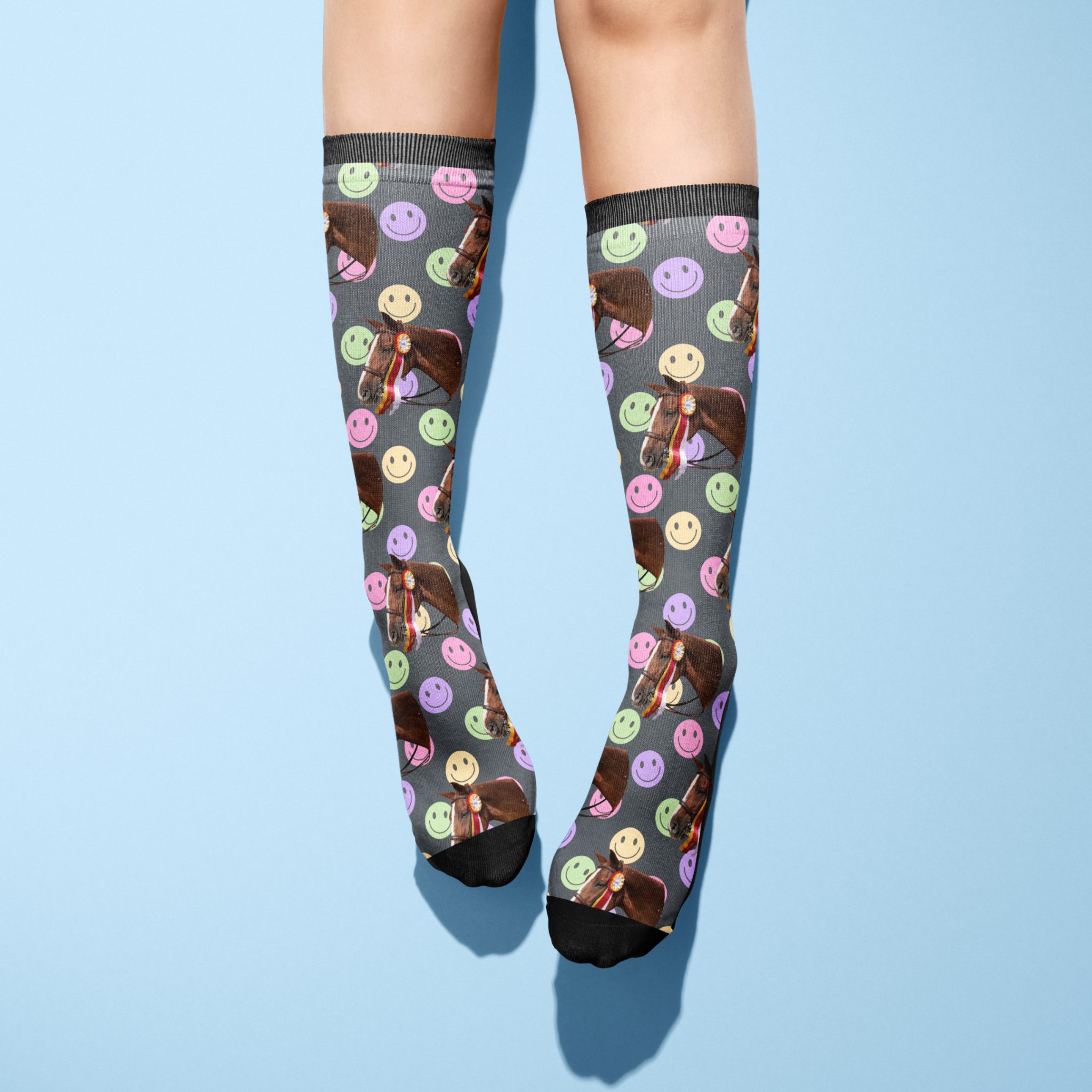 Custom solo socks with smiley face pattern and horse photo design on gray background worn on legs